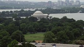 4.8K aerial stock footage of the Jefferson Memorial partially hidden by trees in West Potomac Park in Washington DC Aerial Stock Footage | AX74_093