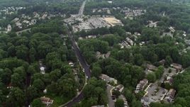 4.8K aerial stock footage flying over suburban homes to approach Burke Town Plaza in Burke, Virginia Aerial Stock Footage | AX74_136E