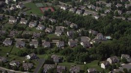 4.8K aerial stock footage flying by neighborhood with white homes in Manassas, Virginia Aerial Stock Footage | AX75_005E