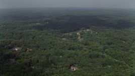 4.8K aerial stock footage flying over forest, approaching upscale homes, Clifton, Virginia Aerial Stock Footage | AX75_008E