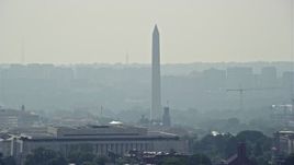 4.8K aerial stock footage of the Washington Monument seen over rooftops in Washington DC Aerial Stock Footage | AX75_066