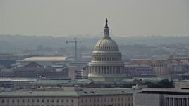 4.8K aerial stock footage of the United States Capitol dome behind the James Madison Building in Washington DC Aerial Stock Footage | AX75_069E