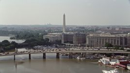 4.8K aerial stock footage approaching heavy traffic on bridge near office buildings and Washington Monument in Washington DC Aerial Stock Footage | AX75_075