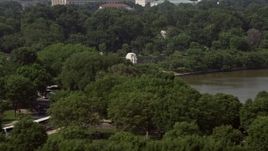 4.8K aerial stock footage flying by trees to reveal Martin Luther King Jr. National Memorial in Washington DC Aerial Stock Footage | AX75_081