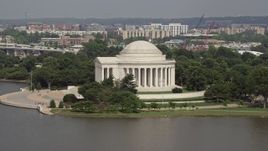 4.8K aerial stock footage flying by the Jefferson Memorial, revealing the Jefferson Statue inside in Washington DC Aerial Stock Footage | AX75_086