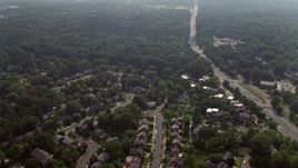 4.8K aerial stock footage approaching and flying over suburban homes next to Highway 50 in Arlington, Virginia Aerial Stock Footage | AX75_143E