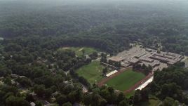 4.8K aerial stock footage flying over Stuart High School beside Lake Barcroft in Falls Church, Virginia Aerial Stock Footage | AX75_145E
