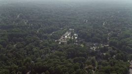 4.8K aerial stock footage flying over tree-lined neighborhoods in Falls Church, Virginia Aerial Stock Footage | AX75_148E