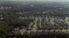 4.8K aerial stock footage flying over suburban homes to approach warehouse buildings in Manassas, Virginia Aerial Stock Footage | AX75_175