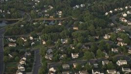 4.8K aerial stock footage tilting to bird's eye view of suburban homes in Manassas, Virginia, sunset Aerial Stock Footage | AX76_003