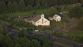 4.8K aerial stock footage of Buckhall United Methodist Church, busy intersections, Manassas, Virginia, sunset Aerial Stock Footage | AX76_004E