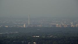 4.8K aerial stock footage of Washington Monument, hazy, Alexandria, Virginia, Washington, D.C., Sunset Aerial Stock Footage | AX76_025