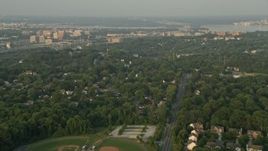4.8K aerial stock footage flying over baseball fields, suburban neighborhoods, Alexandria, Virginia, sunset Aerial Stock Footage | AX76_026E