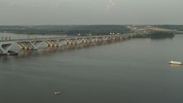 4.8K aerial stock footage of Woodrow Wilson Memorial Bridge, Potomac River, Fort Washington, Maryland, sunset Aerial Stock Footage | AX76_031E