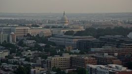 4.8K aerial stock footage of the United States Capitol dome behind Senate Office Buildings, Washington D.C., sunset Aerial Stock Footage | AX76_087
