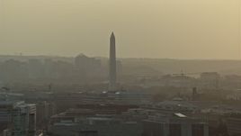 4.8K aerial stock footage of the Washington Monument and office buildings in Washington D.C., sunset Aerial Stock Footage | AX76_092