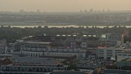 4.8K aerial stock footage of Nationals Park, crowded stadium, Ronald Reagan Airport in the background, Washington D.C., sunset Aerial Stock Footage | AX76_093
