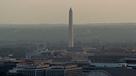 4.8K aerial stock footage of the Washington Monument seen from office buildings in Washington D.C., sunset Aerial Stock Footage | AX76_098