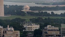4.8K aerial stock footage of the Jefferson Memorial behind the White House, reveal Washington Monument base, Washington D.C., sunset Aerial Stock Footage | AX76_105
