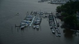 4.8K aerial stock footage flying by docked boats at a marina on the Potomac River, Washington, D.C., twilight Aerial Stock Footage | AX76_174