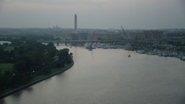 4.8K aerial stock footage approaching Washington Monument, Francis Case Memorial Bridge, and marina near office buildings in Washington, D.C., twilight Aerial Stock Footage | AX76_177