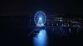 4.8K aerial stock footage of the Capitol Wheel and marina, reveal Gaylord National Resort & Convention Center, National Harbor, Maryland, night Aerial Stock Footage | AX77_015