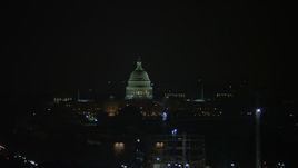 4.8K aerial stock footage of the United States Capitol Building behind cranes in Washington, D.C., night Aerial Stock Footage | AX77_069