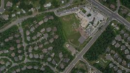 4.8K aerial stock footage of a bird's eye view of homes, Fair Oaks Hospital, reveal Navy Elementary School in Fairfax, Virginia Aerial Stock Footage | AX78_024E