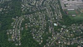 4.8K aerial stock footage of a reverse view of suburban homes, roads, trees, Herndon, Virginia Aerial Stock Footage | AX78_033E