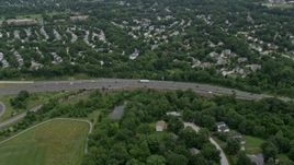 4.8K aerial stock footage flying over suburban neighborhoods and Highway 100 to approach park in Ellicott City, Maryland Aerial Stock Footage | AX78_071E