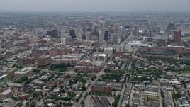 4.8K aerial stock footage tilting from urban homes and streets to reveal and approach Downtown Baltimore skyscrapers, Maryland Aerial Stock Footage | AX78_084E