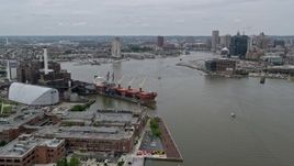 4.8K aerial stock footage approaching Domino Sugar Factory and cargo ship beside Patapsco River, Maryland Aerial Stock Footage | AX78_105