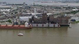 4.8K aerial stock footage of Domino Sugar Factory and a docked cargo ship in Baltimore, Maryland Aerial Stock Footage | AX78_113