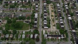 4.8K aerial stock footage tilting from urban row houses, tilt up revealing Herring Run Park, public housing in Baltimore, Maryland Aerial Stock Footage | AX78_122