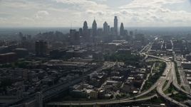 4.8K aerial stock footage tilting from Benjamin Franklin Bridge to reveal skyline of Downtown Philadelphia, Pennsylvania Aerial Stock Footage | AX79_004E