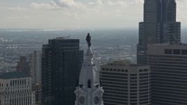 4.8K aerial stock footage approaching William Penn statue on Philadelphia City Hall, Downtown Philadelphia, Pennsylvania Aerial Stock Footage | AX79_038