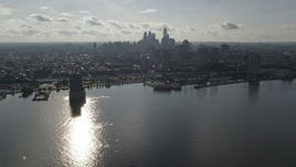 4.8K aerial stock footage flying over Delaware River to approach Downtown Philadelphia skyline, Pennsylvania Aerial Stock Footage | AX79_096