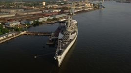 4.8K aerial stock footage of the USS New Jersey on the Delaware River, Camden, New Jersey, Sunset Aerial Stock Footage | AX80_001