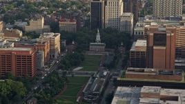 4.8K aerial stock footage of Independence Hall seen across Independence Mall in Downtown Philadelphia, Pennsylvania, Sunset Aerial Stock Footage | AX80_006