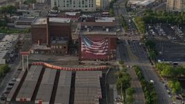 4.8K aerial stock footage of an American flag mural on a warehouse building in Philadelphia, Pennsylvania, Sunset Aerial Stock Footage | AX80_030