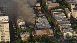 4.8K aerial stock footage of thick smoke from a residential fire near Downtown Philadelphia, Pennsylvania, Sunset Aerial Stock Footage | AX80_037E