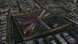 4.8K aerial stock footage flying by Eastern State Penitentiary in Philadelphia, Pennsylvania at Sunset Aerial Stock Footage | AX80_051