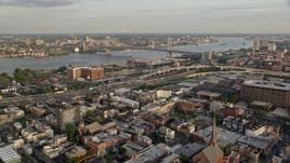 4.8K aerial stock footage of Benjamin Franklin Bridge and Delaware River seen from I-95 in North Philadelphia, Pennsylvania, Sunset Aerial Stock Footage | AX80_072