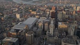 4.8K aerial stock footage flying over Downtown Philadelphia skyscrapers, to reveal Convention Center, City Hall in Pennsylvania, Sunset Aerial Stock Footage | AX80_095