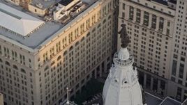 4.8K aerial stock footage of the William Penn statue on top of Philadelphia City Hall, Pennsylvania, Sunset Aerial Stock Footage | AX80_096