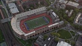4.8K aerial stock footage of a bird's eye view of Franklin Field at University of Pennsylvania, West Philadelphia, Sunset Aerial Stock Footage | AX80_106