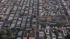 4.8K aerial stock footage of an urban neighborhood around St. Thomas Aquinas Church, South Philadelphia, Pennsylvania Sunset Aerial Stock Footage | AX80_108