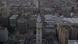 4.8K aerial stock footage approaching Philadelphia City Hall's William Penn statue, Downtown Philadelphia, Pennsylvania, Sunset Aerial Stock Footage | AX80_115E