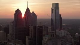 4.8K aerial stock footage of tall Downtown Philadelphia skyscrapers and City Hall, reveal setting sun, Pennsylvania, Sunset Aerial Stock Footage | AX80_146E