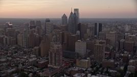 4.8K aerial stock footage of a reverse view of Downtown Philadelphia skyscrapers, Pennsylvania, Sunset Aerial Stock Footage | AX80_149